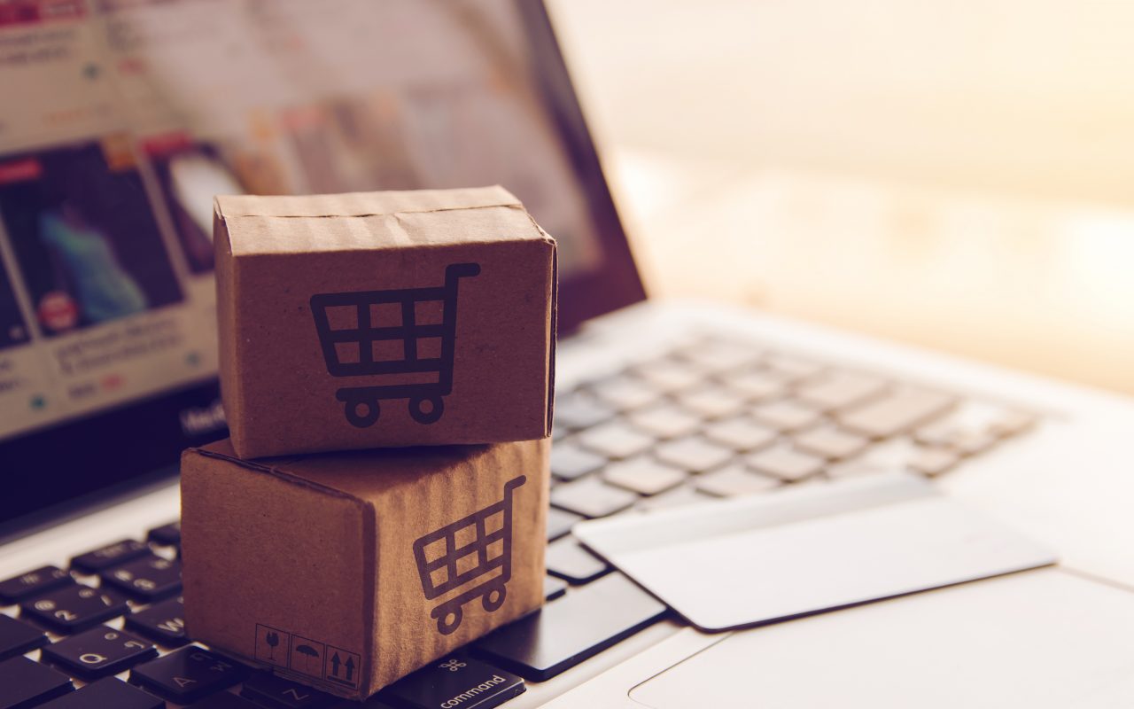 Shopping online concept - Shopping service on The online web. with payment by credit card and offers home delivery. parcel or Paper cartons with a shopping cart logo on a laptop keyboard