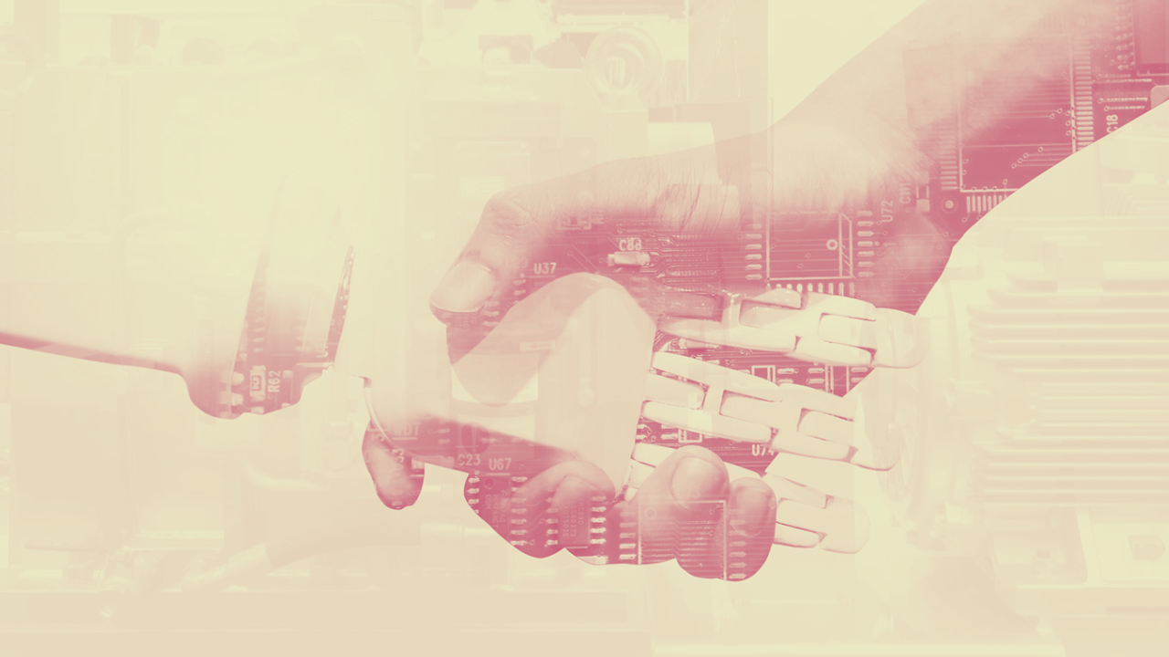 Two hands shaking, one human and one robotic